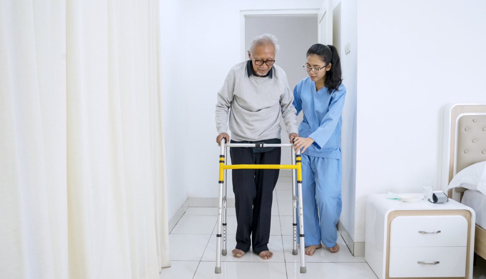 a caregiver assisting an edlerly patient
